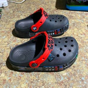 Kids Crocs size 13 Star Wars and solid black pair. Used in good condition.
